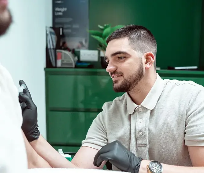 A WellMediCare clinician discussing a weight loss programme with a client